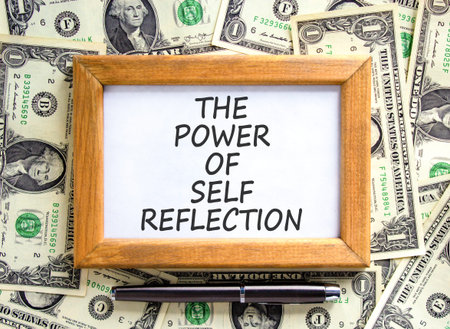 Self reflection symbol. Concept words The power of self reflection on beautiful picture frame. Beautiful dollar bills background. Dollar bills. Business the power of self reflection concept Copy spaceの写真素材