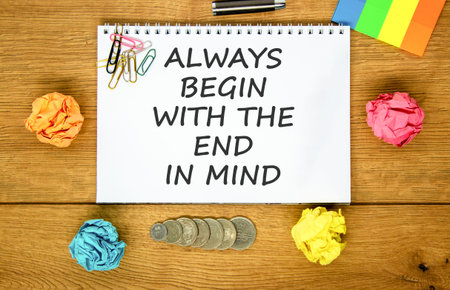 Begin with the end in mind symbol. Concept words Always begin with the end in mind on beautiful white note. Beautiful wooden background. Business begin with the end in mind concept. Copy space.の写真素材