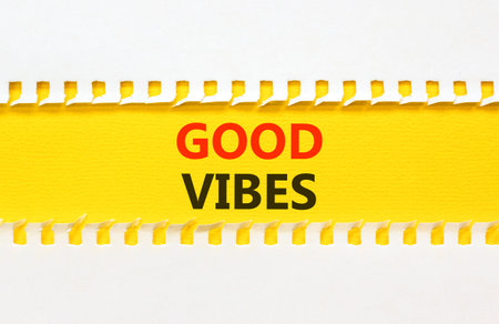 Good vibes words symbol. Concept words Good vibes on beautiful yellow paper. Beautiful white...