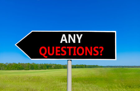 Any questions symbol. Concept words Any questions on beautiful black road sign. Beautiful blue sky...