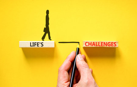 Life's challenges words symbol. Concept words Life's challenges on beautiful wooden blocks. Beautiful yellow background. Businessman hand. Business lifestyle Life's challenges words concept Copy spaceの写真素材