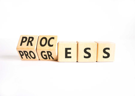 Process and progress symbol. Concept words Process and Progress on beautiful wooden cubes. Beautiful...