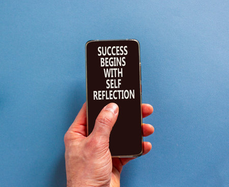 Self reflection symbol. Concept words Success begins with self reflection on beautiful phone screen....