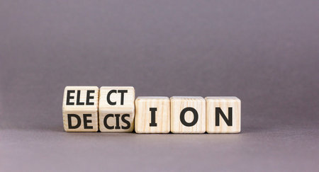 Election and decision symbol. Concept words Election to Decision on beautiful wooden cubes. Beautiful grey table grey background. Business, election and decision concept. Copy space.の写真素材