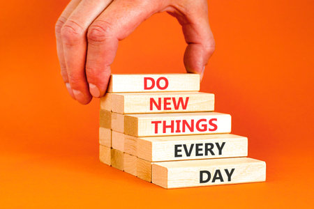 Do new things every day words symbol. Concept words Do new things every day on beautiful wooden...