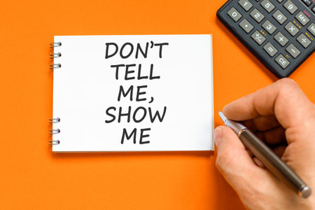 Tell or show symbol. Concept words Do not tell me, show me on beautiful white note. Beautiful orange...