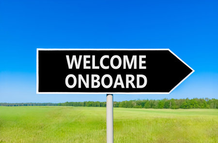 Welcome onboard symbol. Concept words Welcome onboard on beautiful black road sign. Beautiful blue...