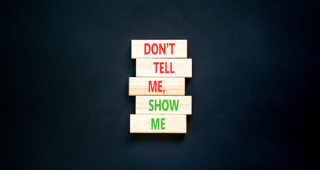 Tell or show symbol. Concept words Do not tell me, show me on beautiful wooden blocks. Beautiful...