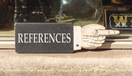 References or reference symbol. Concept word References on beautiful black wooden sign as a hand....