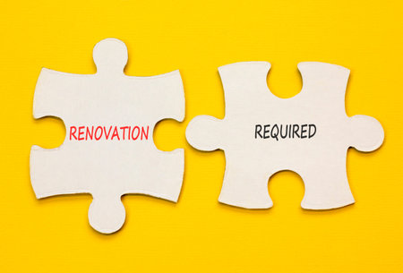 Renovation required words symbol. Concept words Renovation required on beautiful white puzzles....
