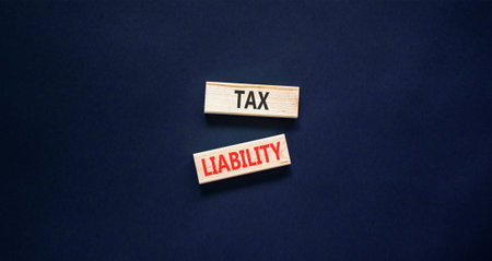 Tax liability words symbol. Concept words Tax liability on beautiful wooden blocks. Beautiful black...