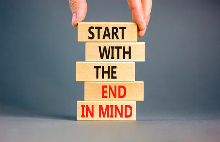 Start with the end in mind symbol. Concept words Start with the end in mind on beautiful wooden blocks. Beautiful grey paper background. Business start with the end in mind concept. Copy space.の写真素材