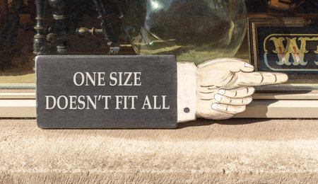 One size does not fit all symbol. Concept words One size does not fit all on beautiful wooden black...