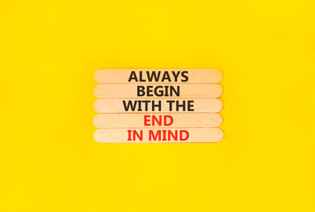 Begin with the end in mind symbol. Concept words Always begin with the end in mind on beautiful wooden sticks. Beautiful yellow background. Business begin with the end in mind concept. Copy space.の写真素材