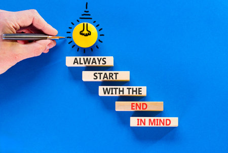 Start with the end in mind symbol. Concept words Always start with the end in mind on beautiful wooden blocks. Beautiful blue background. Business start with the end in mind concept. Copy space.の写真素材