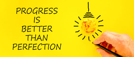 Progress or perfection words symbol. Concept words Progress is better than perfection on beautiful yellow paper. Beautiful yellow background. Business progress or perfection concept. Copy space.