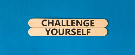 Challenge yourself words symbol. Concept words Challenge yourself on beautiful wooden sticks. Beautiful blue background. Business lifestyle and Challenge yourself words concept. Copy space.