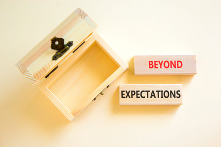 Beyond expectations words symbol. Concept words Beyond expectations on beautiful wooden blocks. Beautiful white background. Empty wooden chest. Business Beyond expectations words concept. Copy space.
