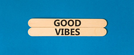 Good vibes words symbol. Concept words Good vibes on beautiful wooden sticks. Beautiful blue background. Business lifestyle and Good vibes words concept. Copy space.