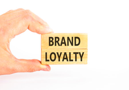 Brand loyalty words symbol. Concept words Brand loyalty on beautiful wooden blocks. Beautiful white background. Businessman hand. Business and Brand loyalty words concept. Copy space.