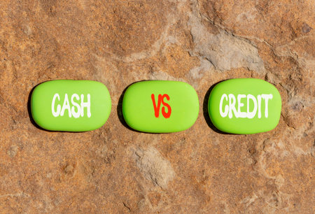 Cash vs credit words symbol. Concept words Cash vs credit on beautiful green stones. Beautiful stone beach background. Business and cash vs credit concept. Copy space.
