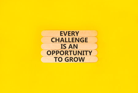 Challenge word symbol. Concept words Every challenge is an opportunity to grow on beautiful wooden sticks. Beautiful yellow paper background. Business challenge is an opportunity concept. Copy space.