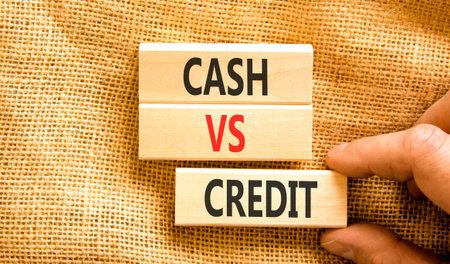 Cash vs credit words symbol. Concept words Cash vs credit on beautiful wooden blocks. Beautiful canvas background. Businessman hand. Business and cash vs credit concept. Copy space.