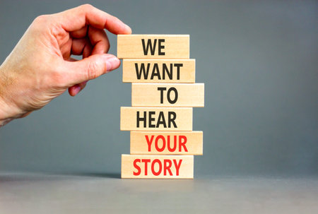 We want to hear your story symbol. Concept words We want to hear your story on beautiful wooden sticks. Beautiful grey background. Business support We want to hear your story concept. Copy space.