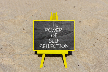 Self reflection symbol. Concept words The power of self reflection on beautiful black blackboard. Beautiful sand beach background. Business the power of self reflection concept. Copy space.