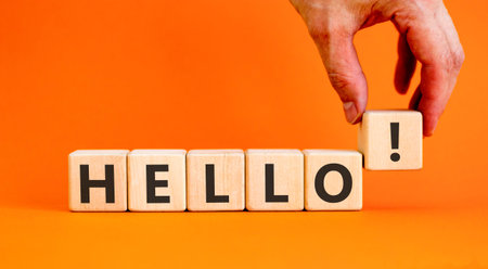 Hello welcome support and help symbol. Concept word Hello on beautiful wooden blocks. Beautiful orange background. Businessman's hand. Business psychological hello support and help concept. Copy space