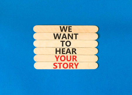 We want to hear your story symbol. Concept words We want to hear your story on beautiful wooden sticks. Beautiful blue background. Business support We want to hear your story concept. Copy space.