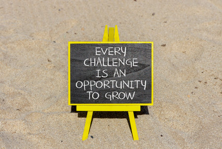 Challenge word symbol. Concept words Every challenge is an opportunity to grow on beautiful black blackboard. Beautiful sand beach background. Business challenge is an opportunity concept. Copy space.