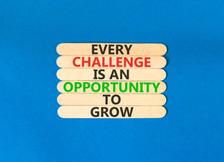 Challenge word symbol. Concept words Every challenge is an opportunity to grow on beautiful wooden sticks. Beautiful blue paper background. Business challenge is an opportunity concept. Copy space.
