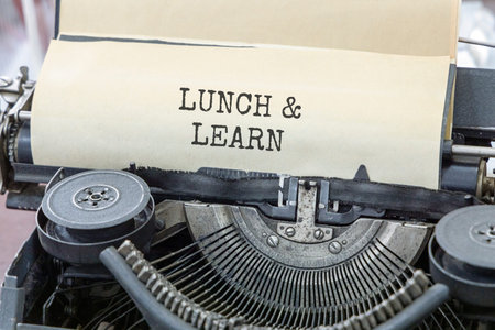 Lunch and learn symbol. Concept words Lunch and learn typed on beautiful old retro typewriter. Beautiful white paper background. Business, educational and lunch and learn concept. Copy space.