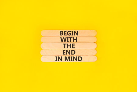 Begin with the end in mind symbol. Concept words Begin with the end in mind on beautiful wooden sticks. Beautiful yellow paper background. Business begin with the end in mind concept. Copy space.