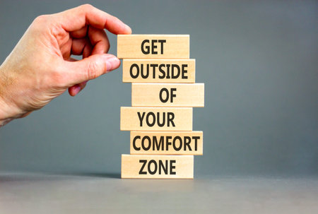 Leave your comfort zone symbol. Concept words Get outside of your comfort zone on beautiful wooden stick. Beautiful grey background. Business psychological Leave comfort zone concept. Copy space.