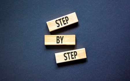 Next step words symbol. Concept words Step by step on beautiful wooden blocks. Beautiful black background. Business and next step concept. Copy space.