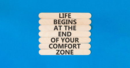 Leave your comfort zone symbol. Concept words Life begins at the end of your comfort zone on beautiful wooden stick. Beautiful blue background. Psychological Leave comfort zone concept. Copy space.