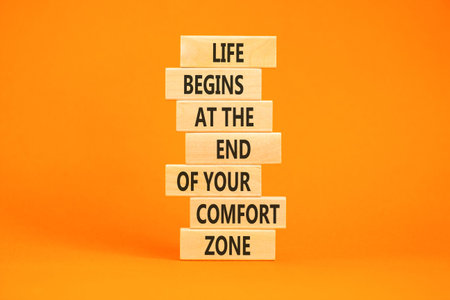 Leave your comfort zone symbol. Concept words Life begins at the end of your comfort zone on beautiful wooden blocks. Beautiful orange background. Psychological Leave comfort zone concept. Copy space.