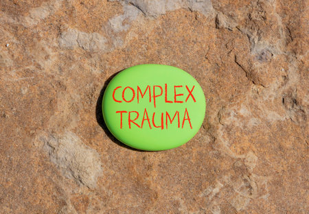 Complex trauma words symbol. Concept words Complex trauma on beautiful green stone. Beautiful brown stone background. Psychological complex trauma support concept. Copy space.