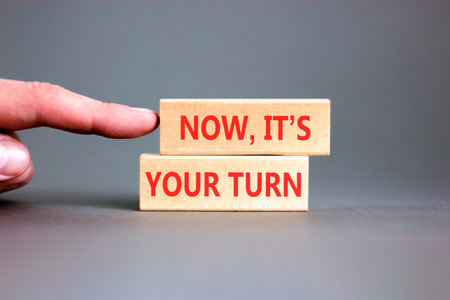 Now it's your turn words symbol. Concept words Now it's your turn on beautiful wooden blocks. Beautiful grey background. Business Now it's your turn motivational support concept. Copy space.