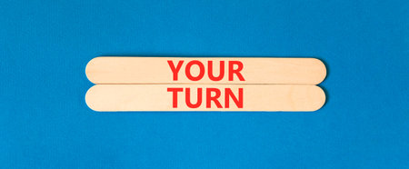 Your turn words symbol. Concept words Your turn on beautiful wooden sticks. Beautiful blue background. Business your turn motivational support concept. Copy space.