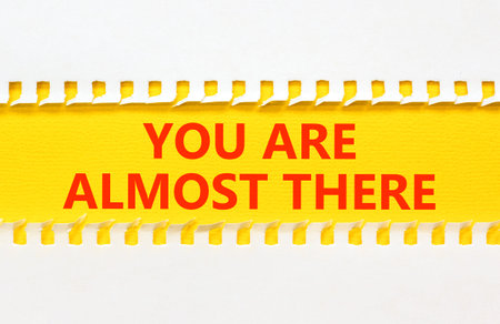 You are almost there words symbol. Concept words You are almost there on beautiful yellow paper. Beautiful white background. Business You are almost there motivational support concept. Copy space.