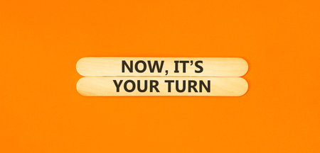 Now it's your turn words symbol. Concept words Now it's your turn on beautiful wooden sticks. Beautiful orange background. Business Now it's your turn motivational support concept. Copy space.