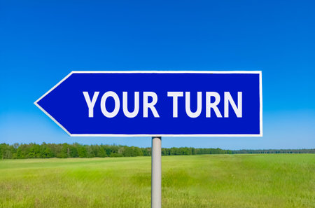 Your turn words symbol. Concept words Your turn on beautiful blue road sign. Beautiful blue sky green field background. Business your turn motivational support concept. Copy space.