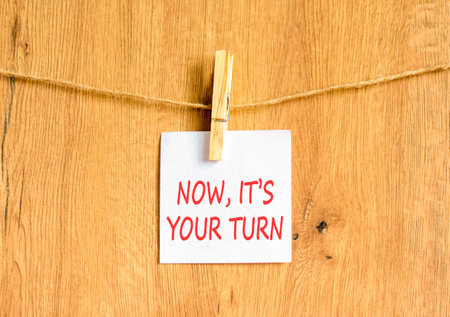 Now it's your turn words symbol. Concept words Now it's your turn on beautiful white paper. Beautiful wooden background. Business Now it's your turn motivational support concept. Copy space.