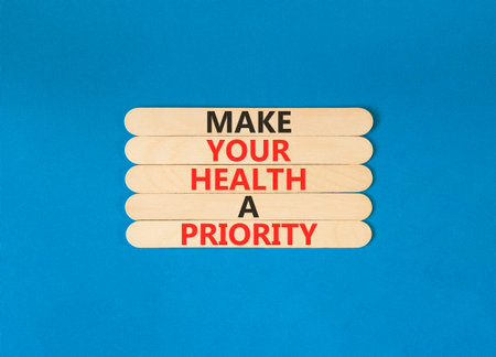 Make your health a priority symbol. Concept words Make your health a priority on beautiful wooden sticks. Beautiful blue background. Medical make your health a priority concept. Copy space.
