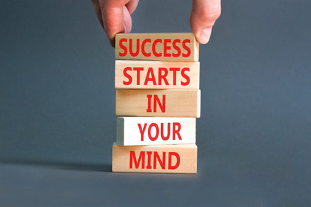 Success starts in your mind symbol. Concept words Success starts in your mind on beautiful wooden blocks. Beautiful grey background. Business and success starts in your mind concept. Copy space.