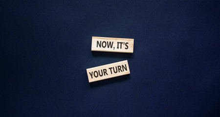 Now it's your turn words symbol. Concept words Now it's your turn on beautiful wooden blocks. Beautiful black background. Business Now it's your turn motivational support concept. Copy space.