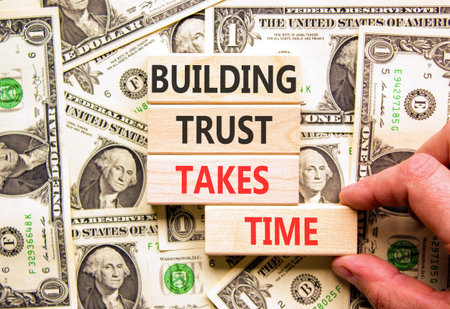 Building trust takes time words symbol. Concept words Building trust takes time on beautiful wooden blocks. Beautiful dollar bills background. Business building trust takes time concept. Copy space.